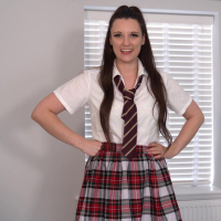 Busty brunette girl Ivy Rain peels off sexy plaid skirt and rubs pussy