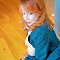 Ginger MILF Red XXX seduces in a bossy costume