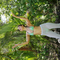 Lovely Melena Maria Rya posing in a green bikini outdoors