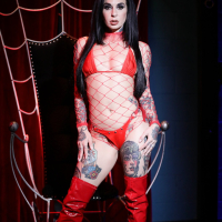 Sexy Joanna Angel in a red fishnet top and boots