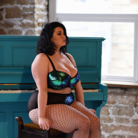 Chubby chick Kiki in mesh stockings plays with her massive melons