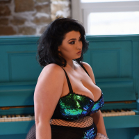 Chubby chick Kiki in mesh stockings plays with her massive melons