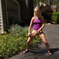 Kinky gardener Braylin Bailey plays with carrot