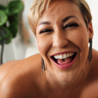 Happy MILF Ryan Keely rubs her aroused clitoris