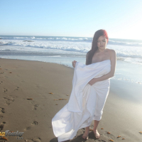 Tessa Fowler on the Beach showing her Melons