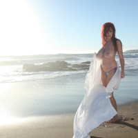 Tessa Fowler on the Beach showing her Melons