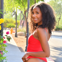 Chocolate hottie Olivia Jayy poses in red dress