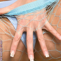 Sandra Shine strips fishnets for blue dildo