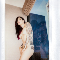 Amateur model Joanna Angel showing off her tattoo sleeve and bald pussy