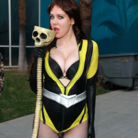 Busty Maitland Ward wearing latex bodysuit fishnets and boots at the Long Beach