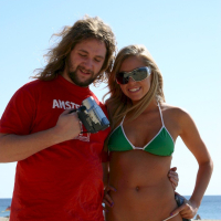 Juicy blonde Brynn Tyler posing in a green bikini on the beach