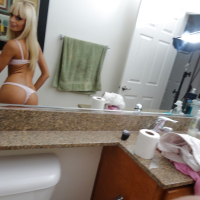 Blonde exgirlfriend Erica Fontes taking mirror self shots while undressing