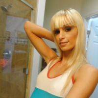 Blond chick Erica Fontes taking selfies in mirror while taking off her clothes
