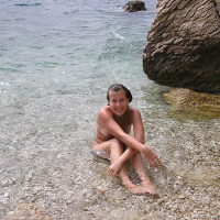 Young nudist girl swimming naked