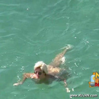 Cute naked blonde enjoys the cold water