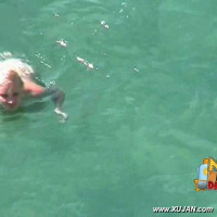 Cute naked blonde enjoys the cold water