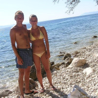 Young nudist couple posing outdoors