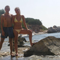 Young nudist couple posing outdoors