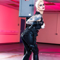 Tattooed Euro model Mila Milan flaunting big tits in leather and boots