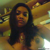 Pretty ebony chick taking photos of her nice boobs