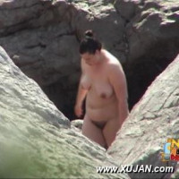 Chubby dark hair Latina walking naked on a public beach