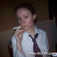 Sweet young schoolgirl smokes a cigarette