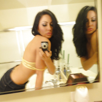 Brunette slut Tiffany Brookes taking mirror self shots while undressing