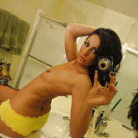 Brunette slut Tiffany Brookes taking mirror self shots while undressing