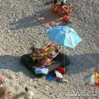 Young couple decides to snuggle under the umbrella