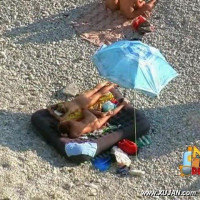 Young couple decides to snuggle under the umbrella