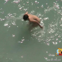 Hot brunette filmed while naked getting by the sea