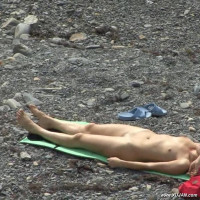Slim naked girl caught on camera while tanning