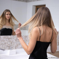 Slim model by the mirror
