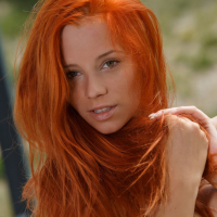 Alluring redhead Ariel Piper Fawn freeing nice MILF tits during glam spread
