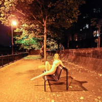 Blond girl posing nude in the night outdoor