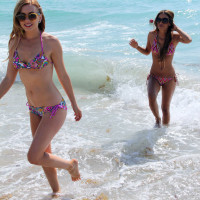 Lexi Belle and her lesbian girlfriend model bikinis during a trip to the ocean