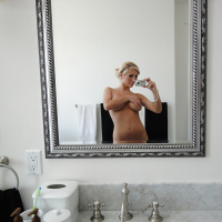 Beautiful blonde Tasha Reign taking selfies in mirror while removing pretties