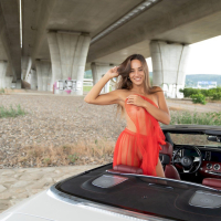 Pretty girl Dominika C showing off her landing strip in a car outdoors