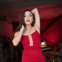 Sexy brunette Amber Summer takes off her red dress to ride a dick