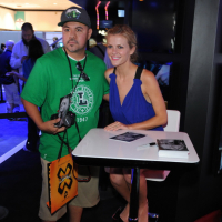 Brooklyn Decker showing big cleavage in blue mini dress at PlayStation booth at
