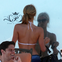 Paris Hilton showing her hard pokies in white transparent bikini top on the beac