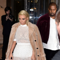 Kim Kardashian in a white mesh dress leaving her hotel in Paris