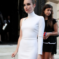 Emma Roberts wearing tight white mini dress with Mena Suvari at Versace show dur