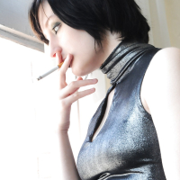 Tattooed brunette Violet Monroe smoking cigarette while flashing underwear