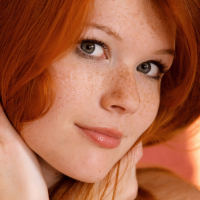 Redhead glamour model Mia Sollis posing in black lingerie in teasing manner