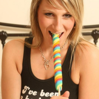 Pictures of busty schoolgirl Demi sucking her lollipop in bed