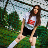 Hot brunette girl Anastasia Lipov posing on the soccer field