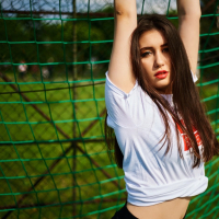 Hot brunette girl Anastasia Lipov posing on the soccer field