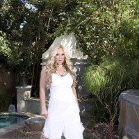 Tyler Faith Posing in a white Dress Outdoors