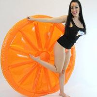 Kayla Kiss strips for you on her big orange inflatable